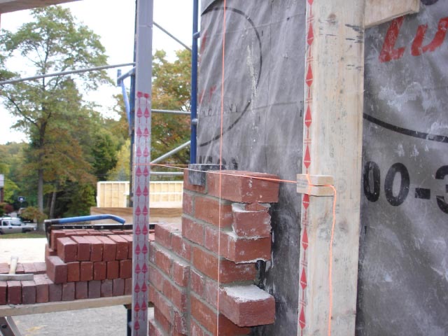 Builder using KwikTape on a wall layout