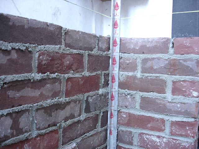 2-inch wide red spacing tape on a brick story-pole corner